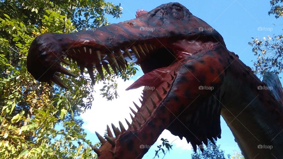 Scary, big toothed dinosaur at the Awesome free model Dinosaur trail in Northeast TN.