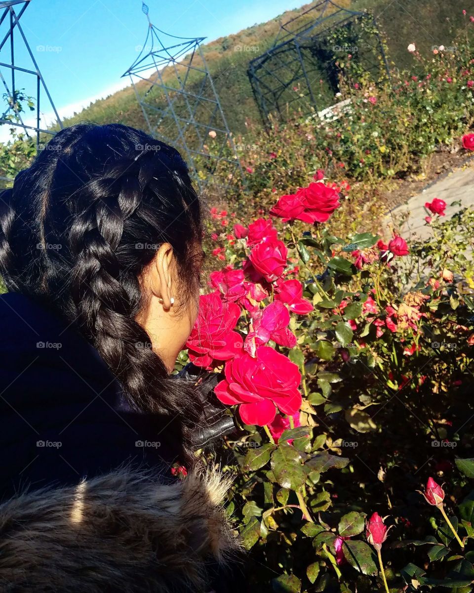 Smelling red roses