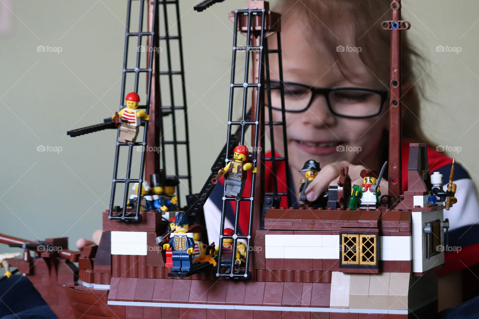 Child playing with Lego Pirates