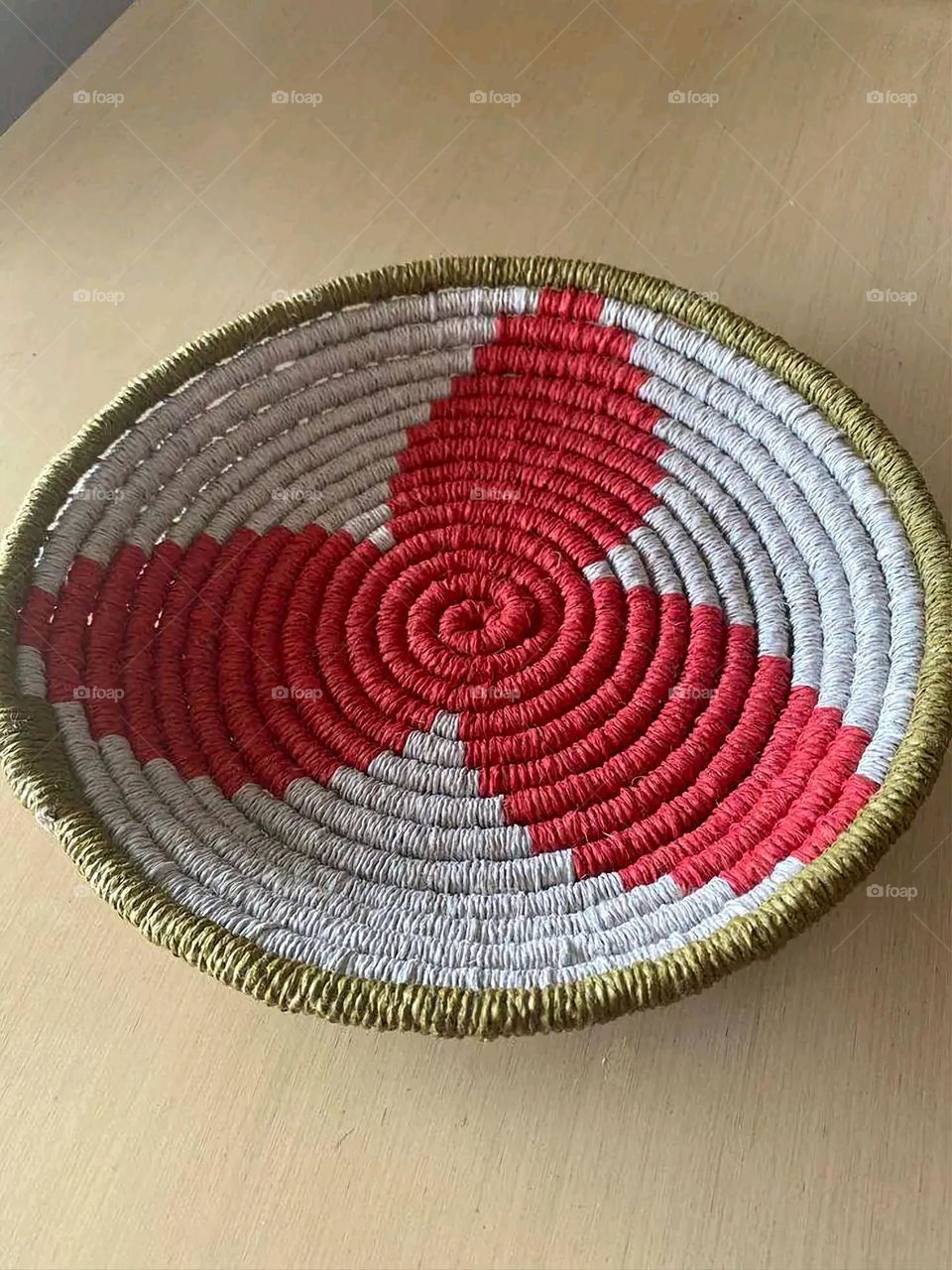 The image shows a group of hand -made dishes of wicker, decorated with colored embroideries with beautiful floral shapes, and is elegantly displayed in a warm corner that combines heritage and beauty, which gives the place an artistic spirit and attr