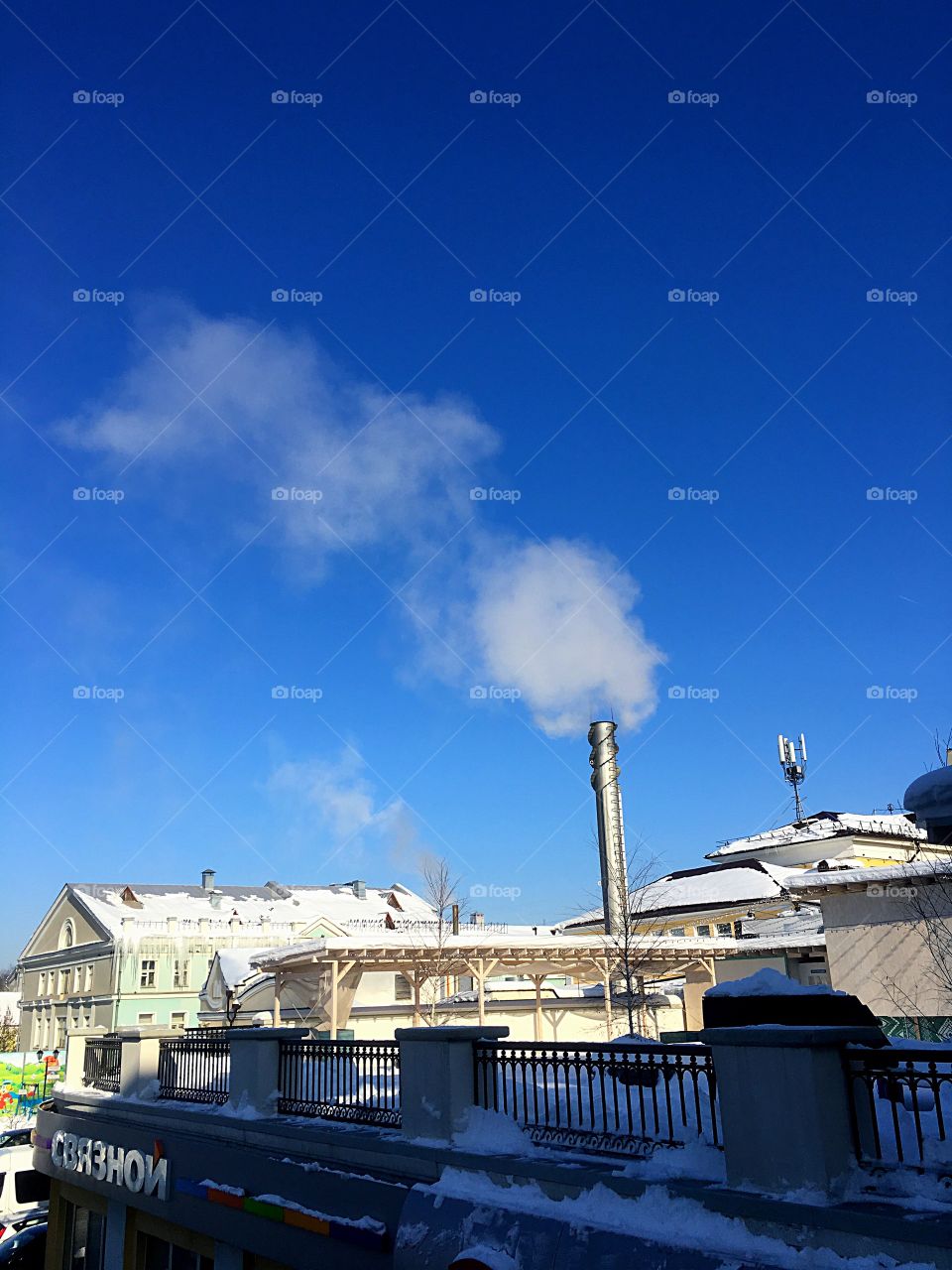smoke from a chimney against a blue sky