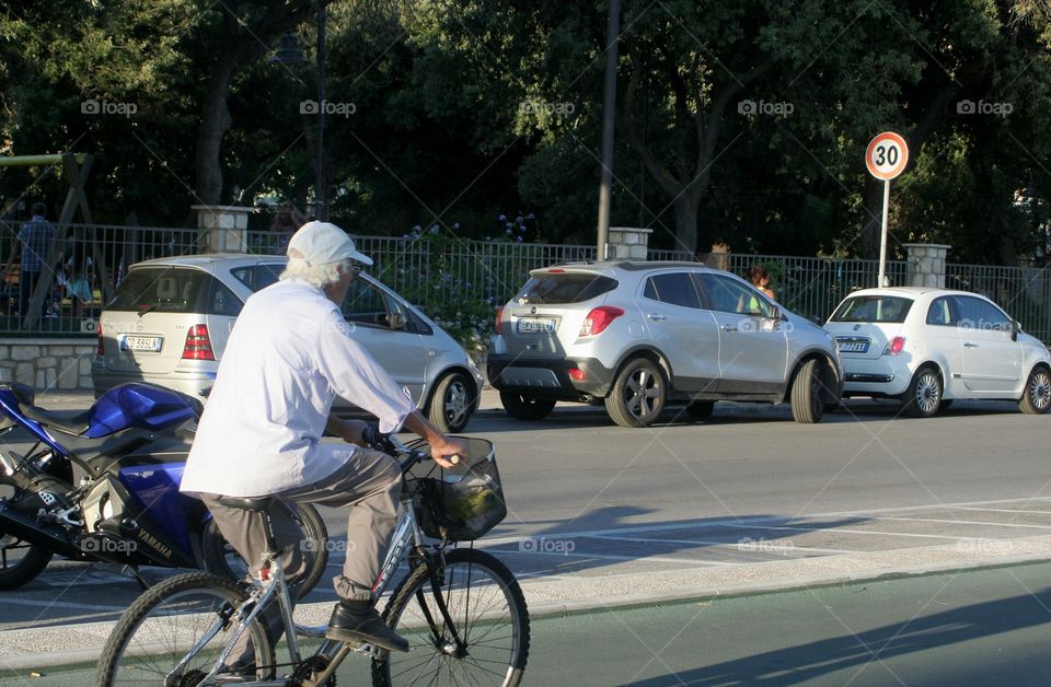 Old man on his bicycle enjoys a nide day
