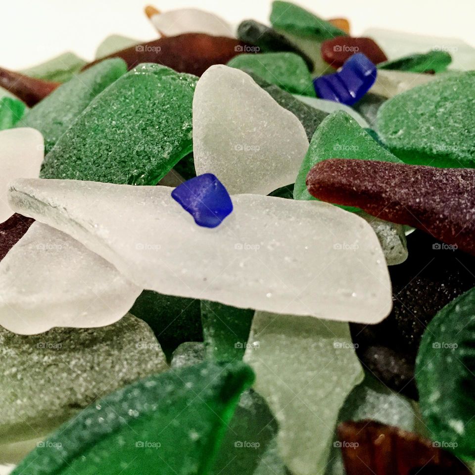 Sea glass from beach in a pile, pile of sea glass, colorful sea glass from the Caribbean, finding sea glass in the ocean 