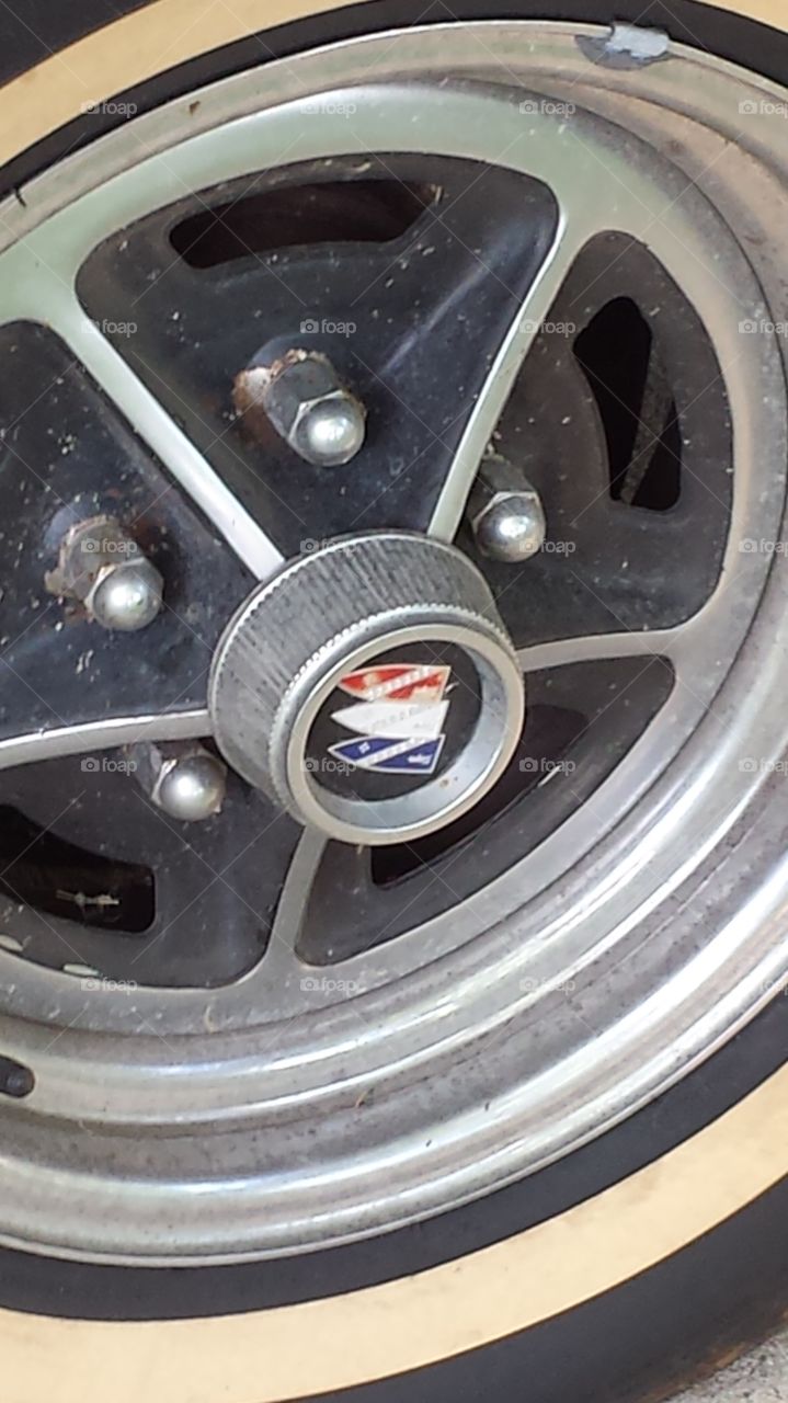 Closeup of Buick hubcap .