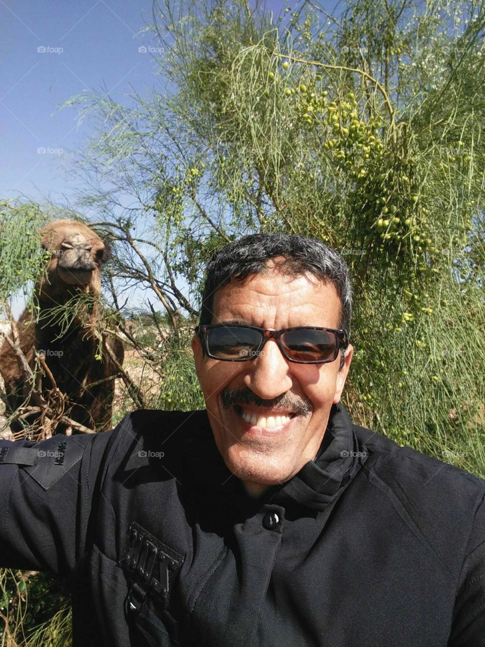 I m smiling and a camel behind me.