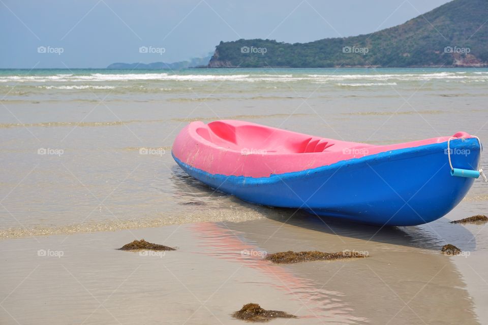 Colourful kayak on the beach.