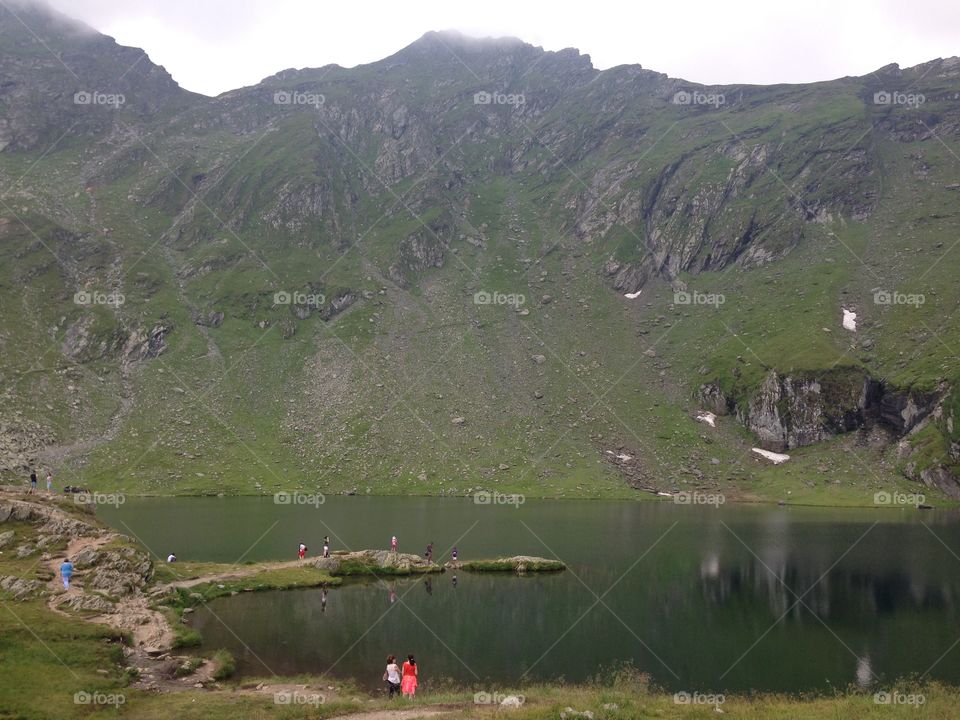 Mountain Lake. People traveling around the beautiful Balea Lake in Romania