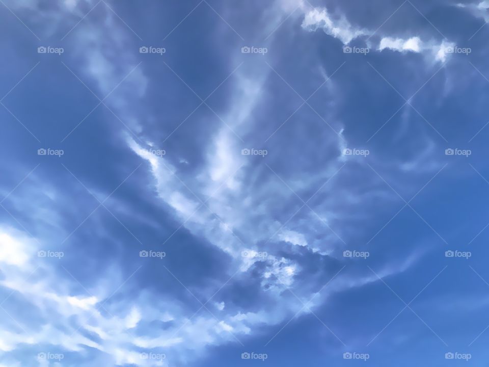 Silky white clouds in an azure sky.