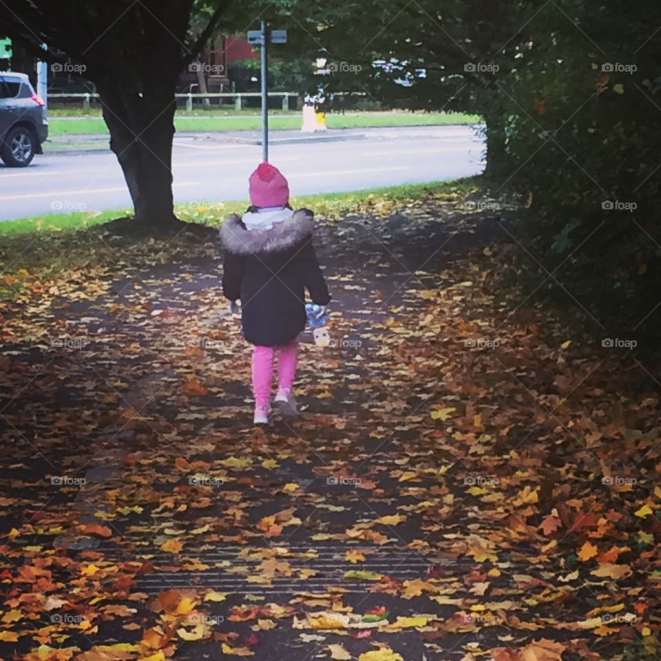 Daughter autumn leaves walk