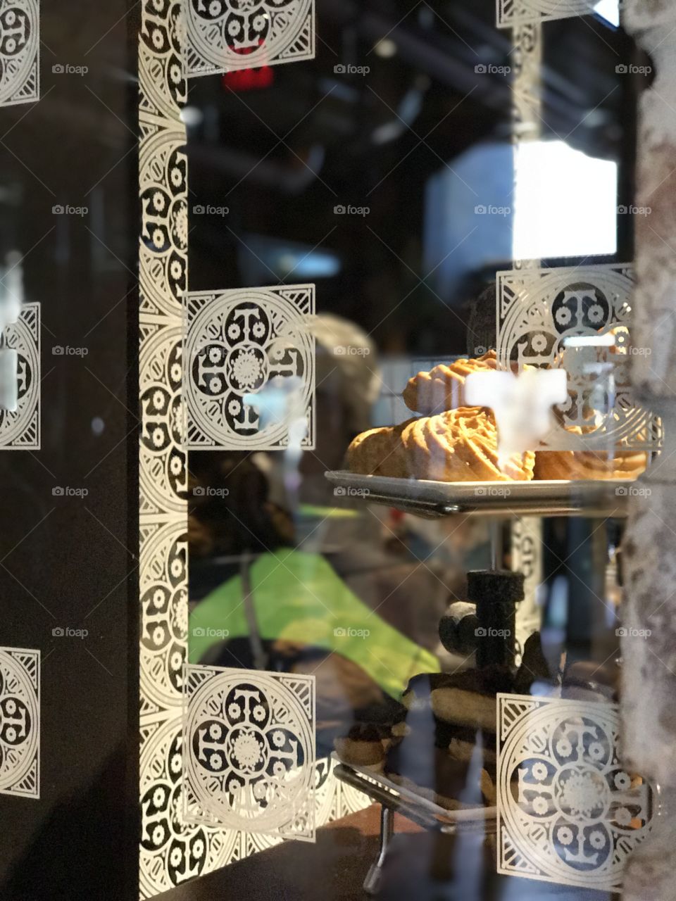Fresh made pastries reflecting decorative window