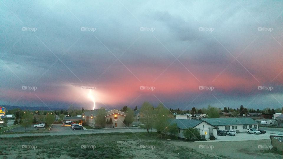 Red lightning. Red sunset with lighting strike over the Pinedale, WY Skyline
