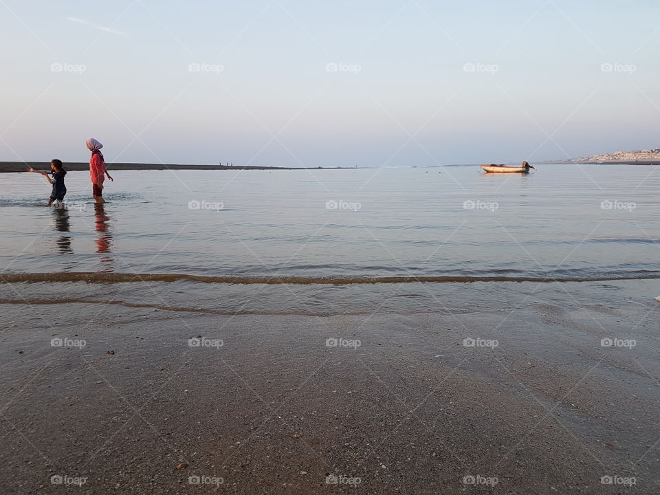 i love water. playing with water. child water boat and city . Morocco
