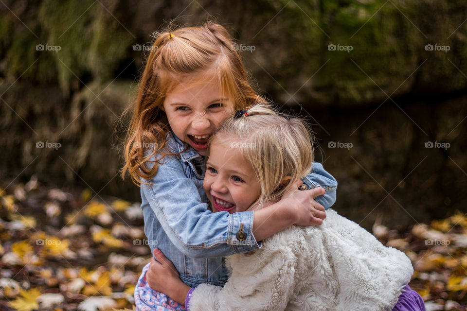 Two happy girls hugging