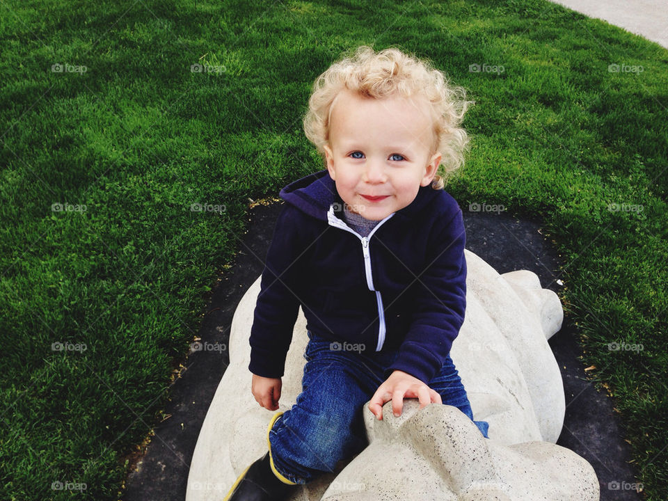 Cute little boy smiling at the park.