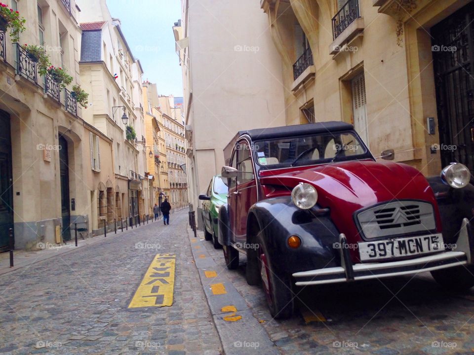 Auto in Paris. An vintage automobile sits on the historic, cobblestone streets of Paris. 