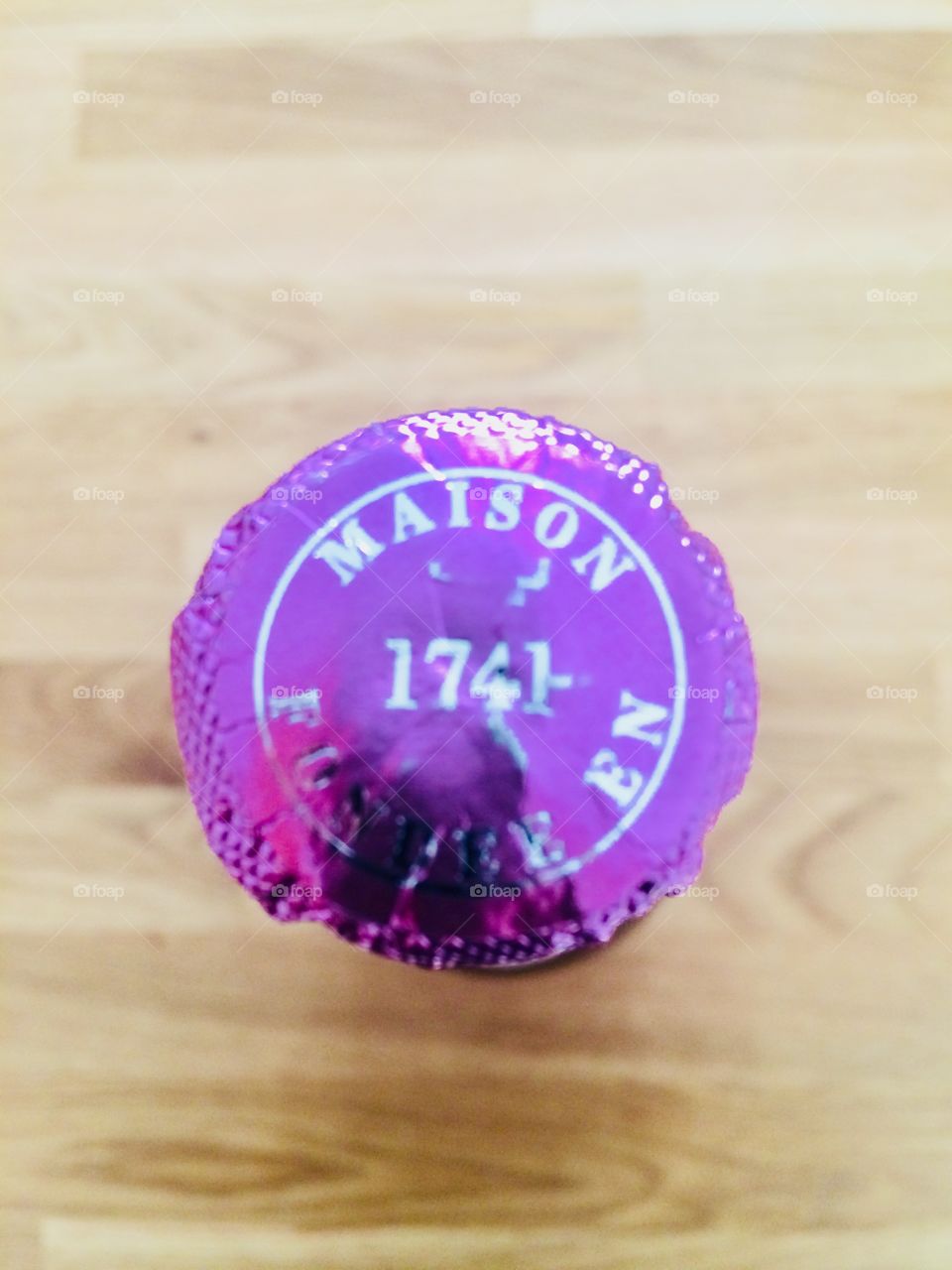 A Bottle of Champagne from above with a pink label