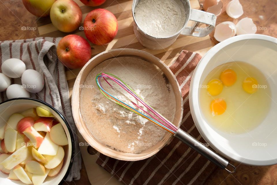 Making homemade puffed apple pie with eggs, sugar and flour.