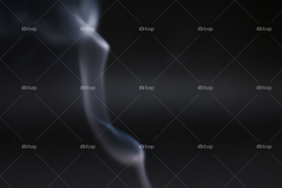 Smoke scented candles on a black background