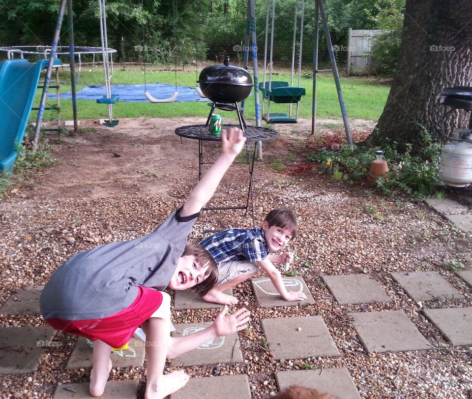 Two brothers playing in the backyard enjoying the day!
