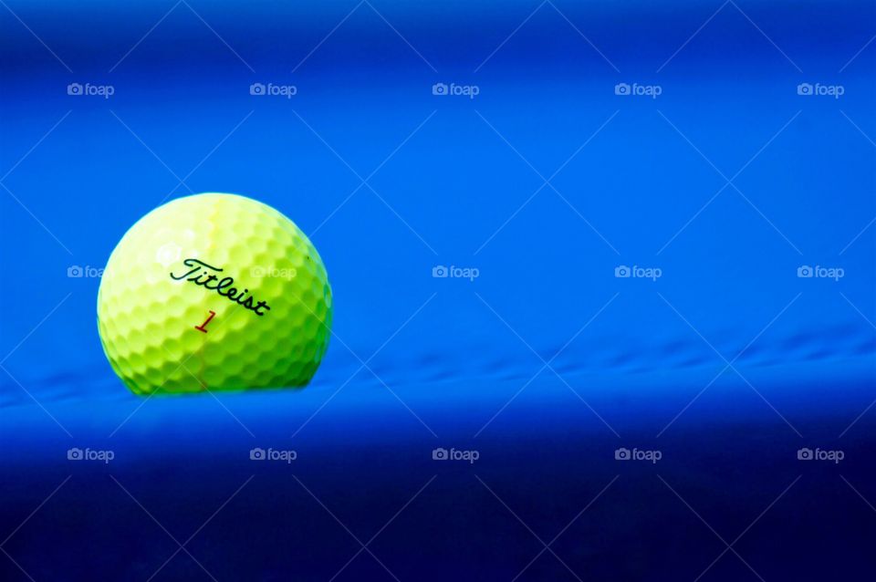 Golf ball on blue
