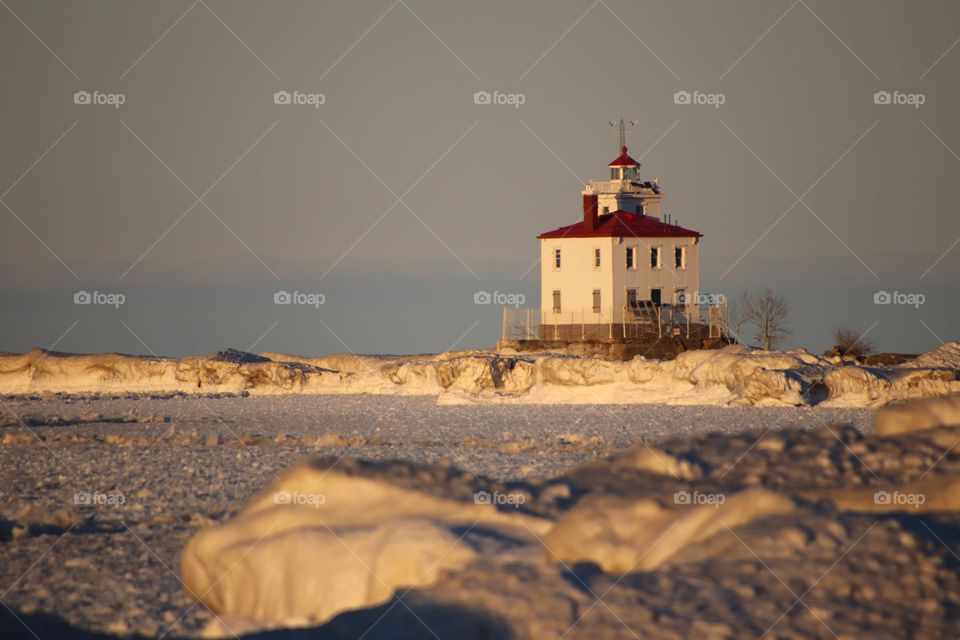 Fairport harbor West breakwater lighthouse at sunset in Winter