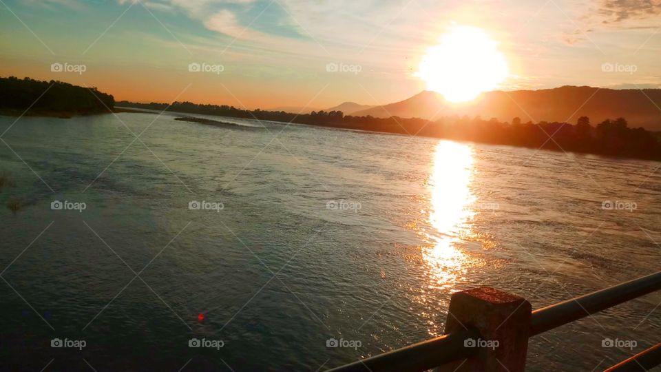 sun rises in the east. This is the narayani river of nepal where sun is rising.