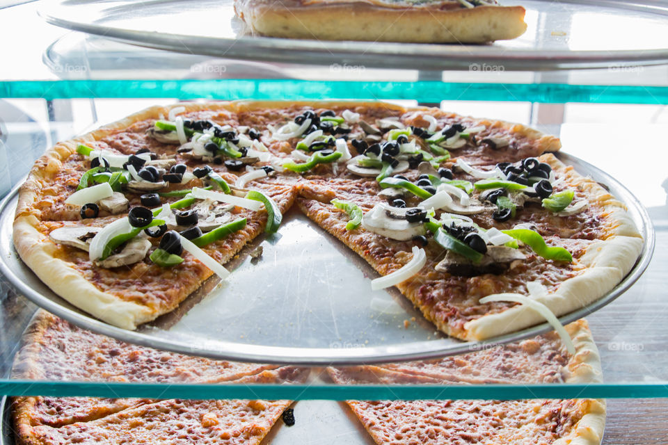 Pizza in a display case