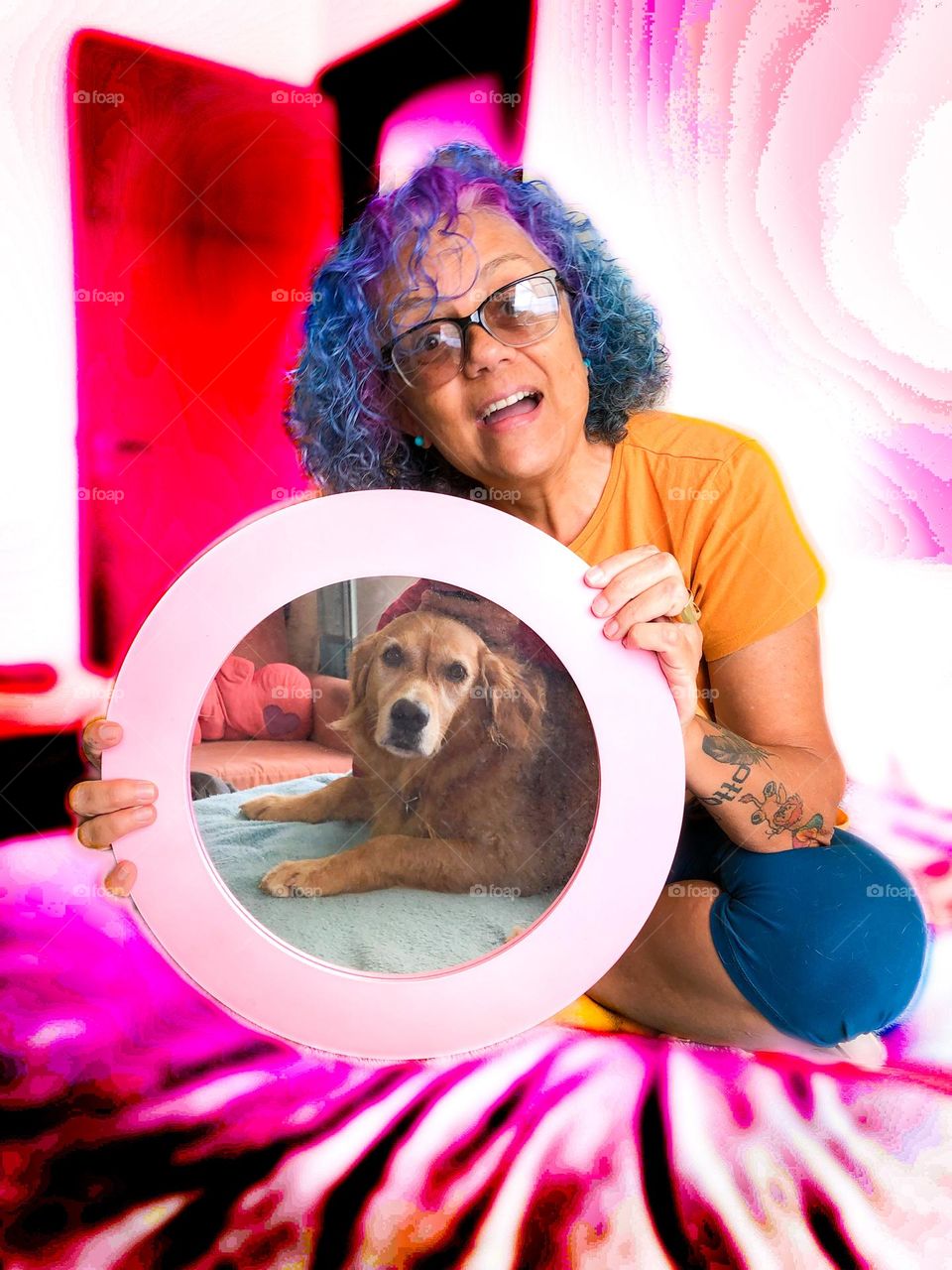 A golden retriever and her human looking at each other while the human tries to draw the dog’s attention to the mirror. 