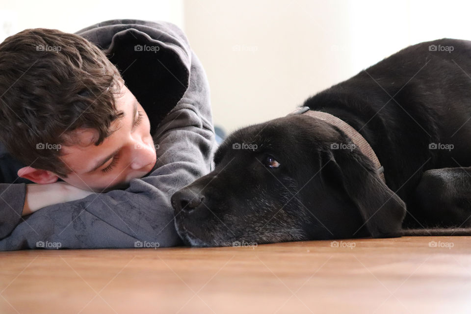 Young teen and black labrador