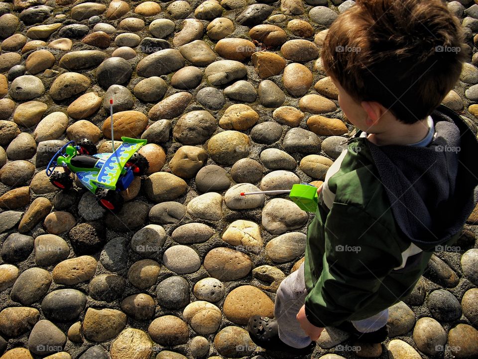 Boy Playing With His Remote Control Car
