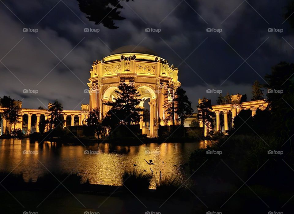 Nighttime at the Palace of Fine Arts in San Francisco California, this beautiful Beaux-Arts designed building by Bernard Maybeck for the 1915 Panama-Pacific International Exposition was meant to resemble Roman Ruins, looking across the lagoon 