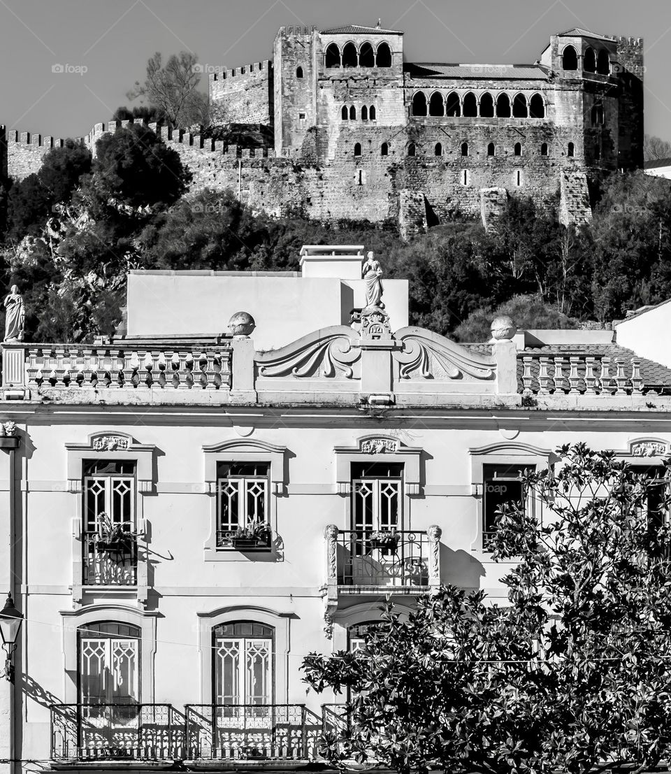 A view of Art Art Nouveau houses in Praça Rodrigues Lobo, in contrast with the mediaeval Castelo de Leiria in the background