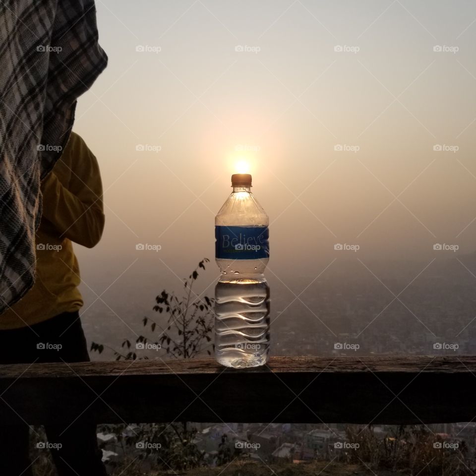 sunrise at the cap of water bottle