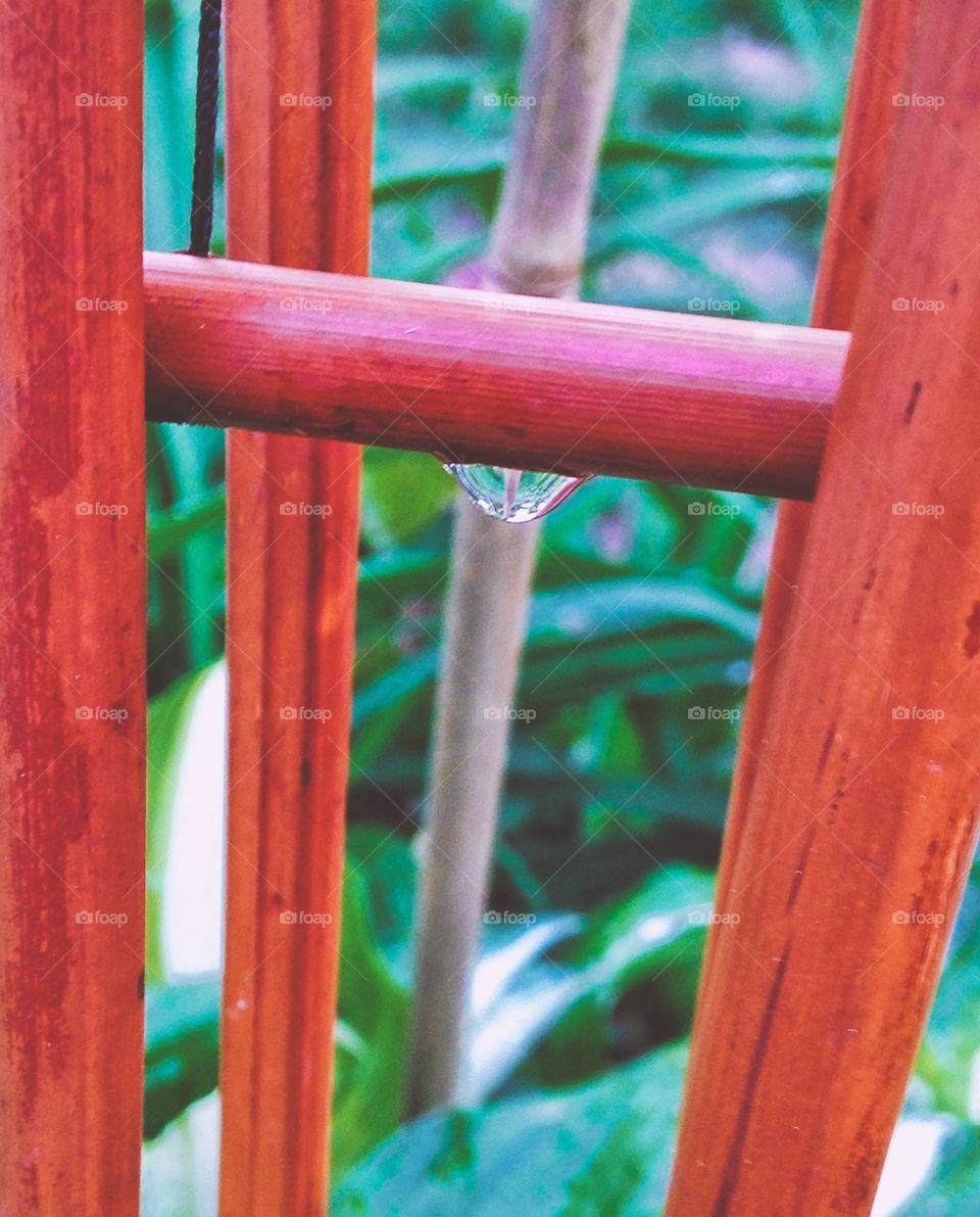 Watering the plants . Bead of water on bamboo chimes