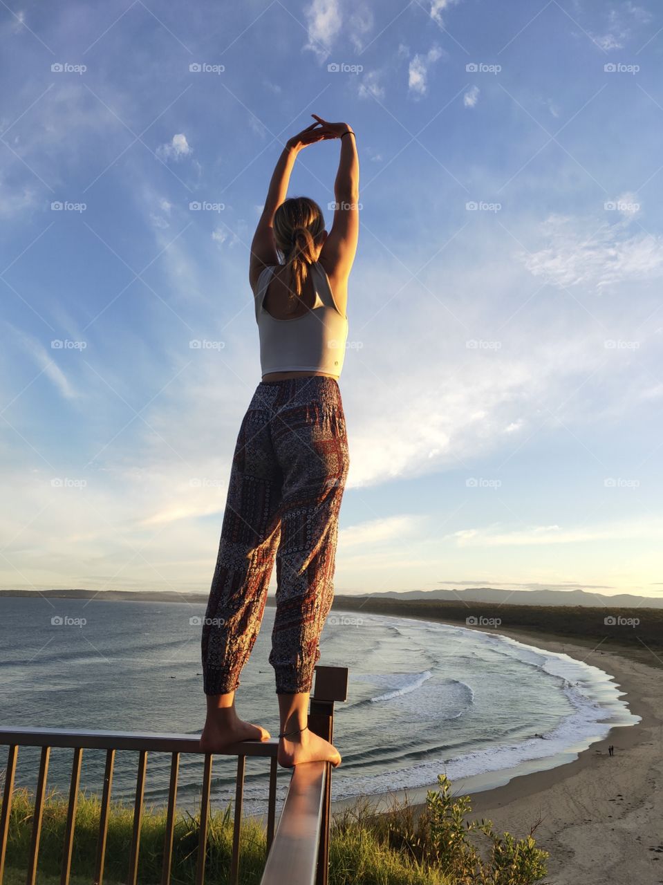 Sunset yoga overlooking a beautiful beach.