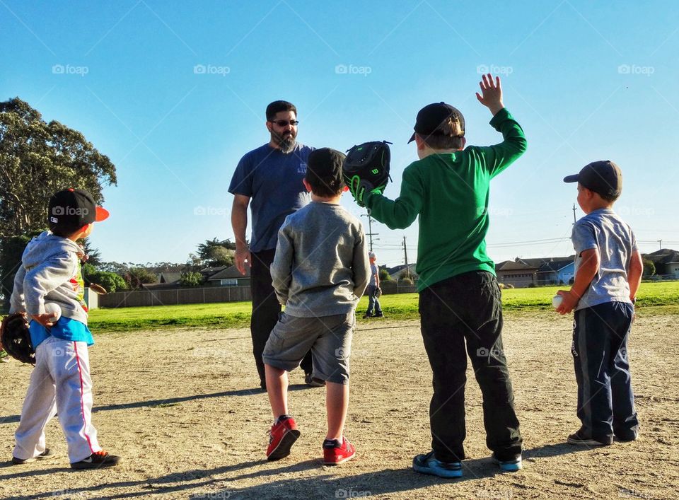 Little Boys At Baseball Practice Cheering A Victory
