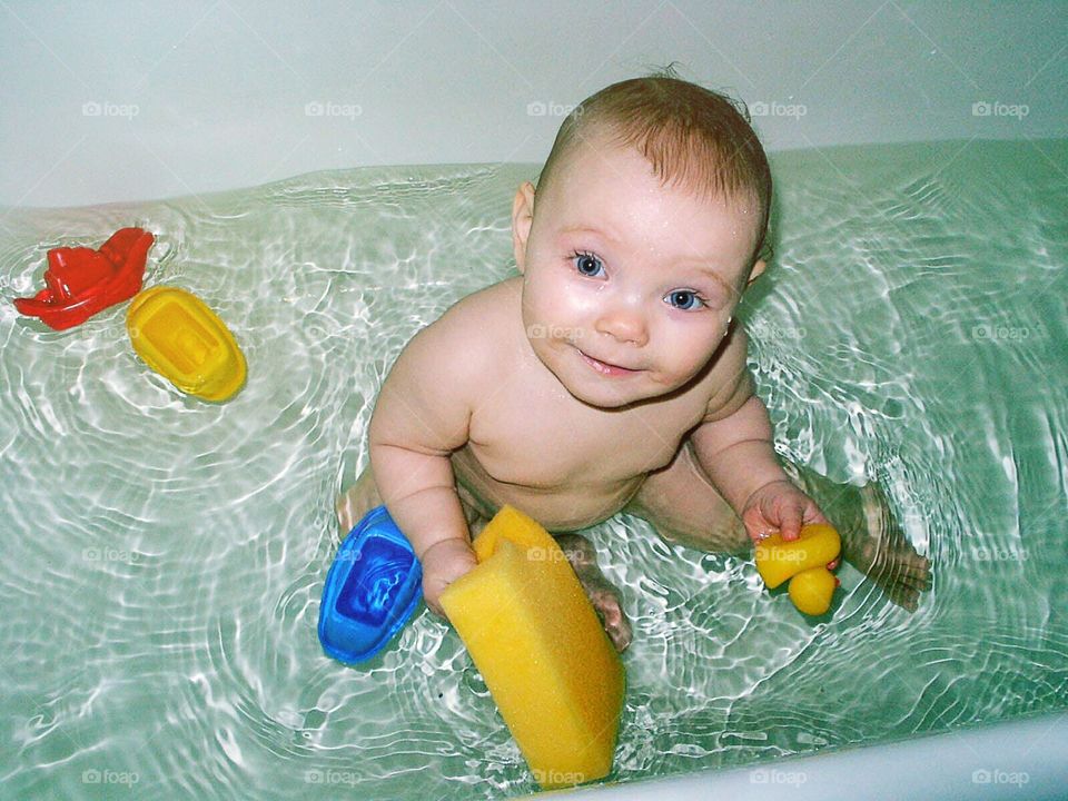 Baby bathing in the tub