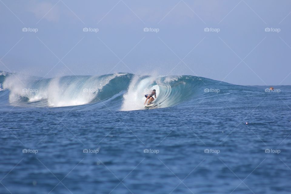 Surfer getting barreled 