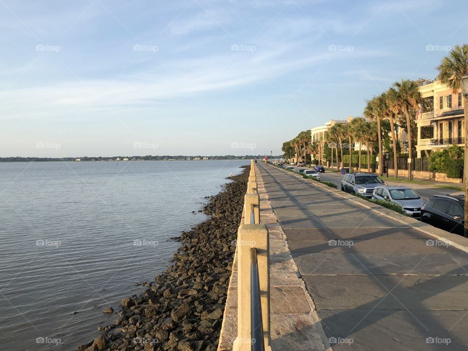 Water scene on left side of pic, with long sidewalk on left. Calm and tranquil features. Pic taken at the battery downtown Charleston, South Carolina, USA