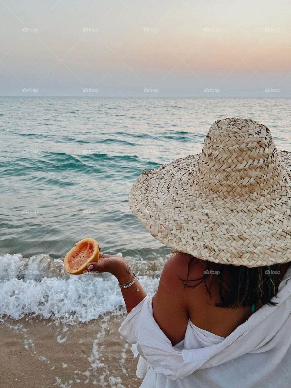 The sun was setting and the sky had turned orange and red. She walked by the sea and look at the waves, how they reached the shore slowly and continuously. The sound of sea birds, the smell of salt, freedom and peace were in the air...