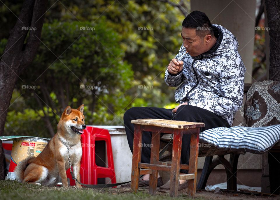 A man with his dog relaxing outdoor