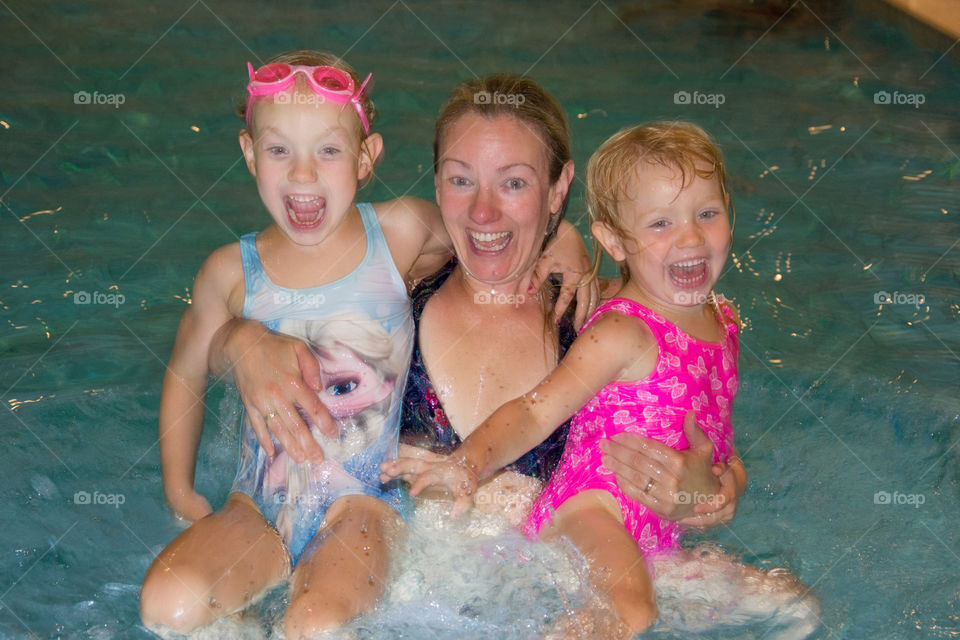 Mom with her two girls swimming in a pool at a hotel in Denmark.