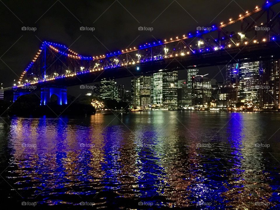 Night view of high rise buildings over the bridge