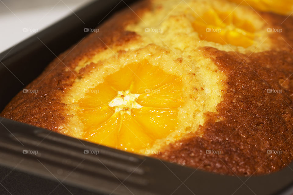 Delicious and fluffy homemade orange bread in a baking tray