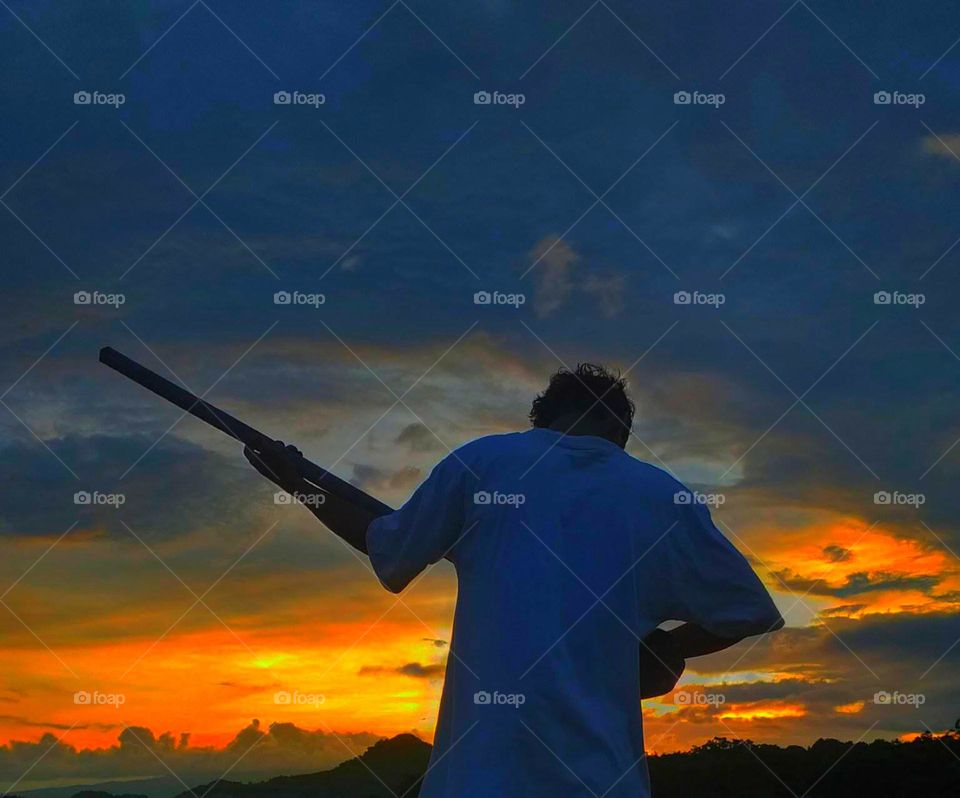 playing guitar while watching the sunset