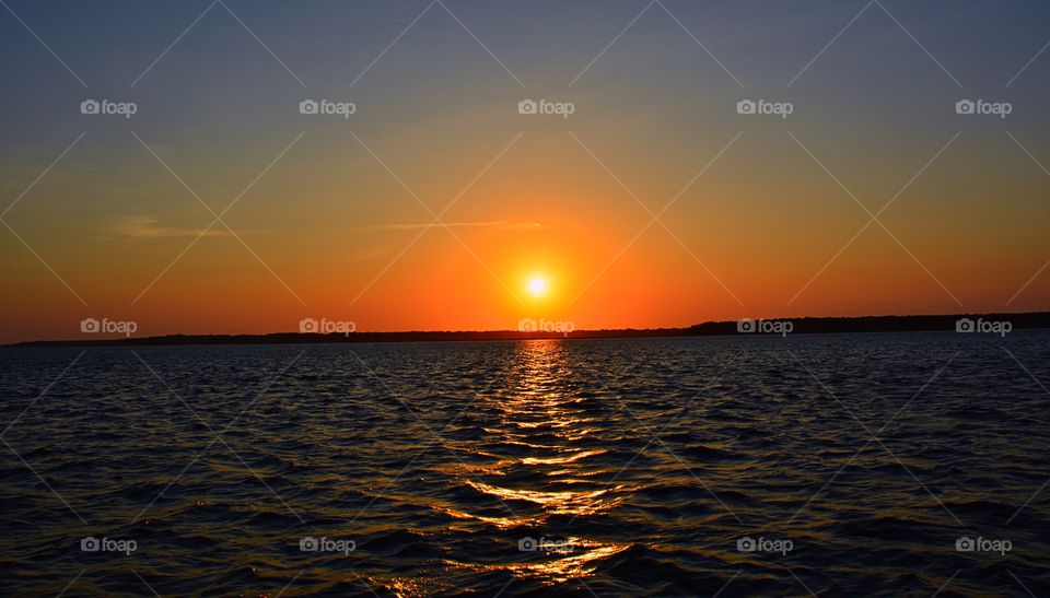 Sun reflecting on sea at sunset