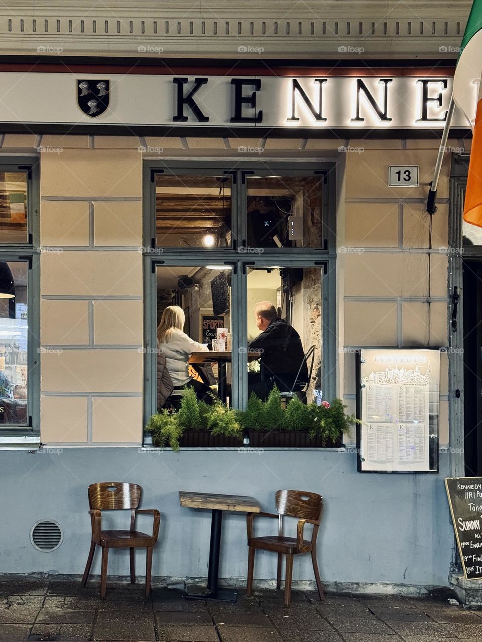 The older couple is sitting in Irish bar