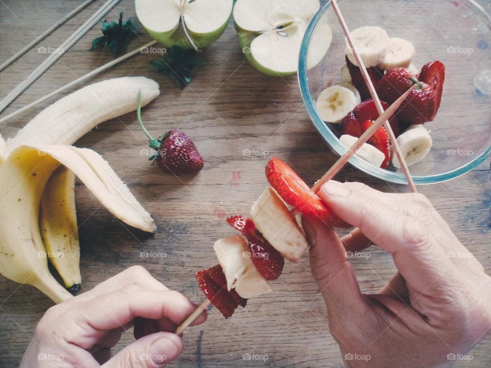 Person making fruit salad