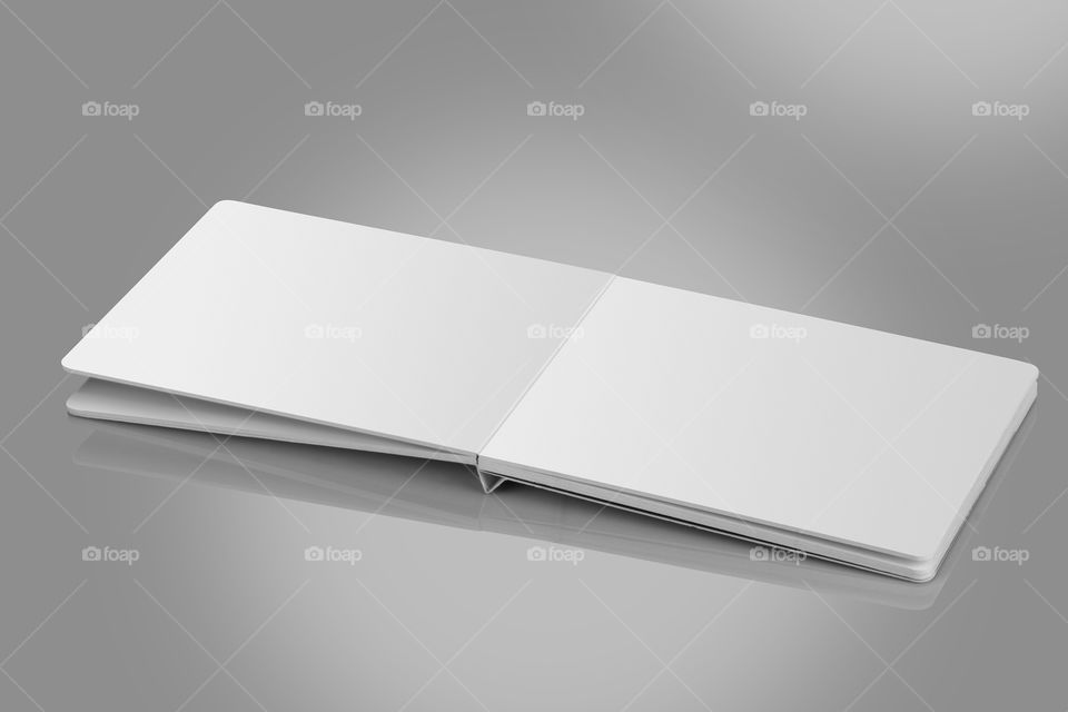 Open blank white brochure on white reflective background