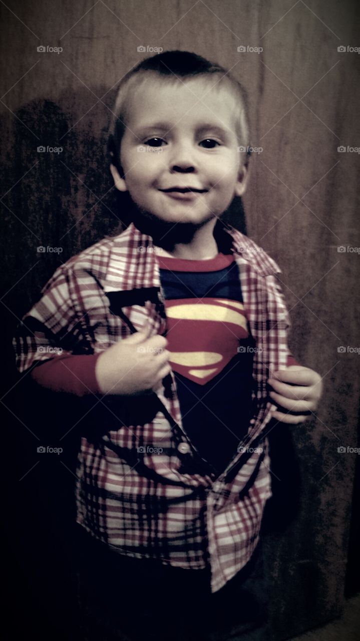 boy dressed in superman shirt